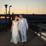 bride and groom walking on dock